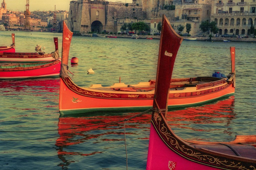 Traditional luzzu fishing boats in Marsaxlokk harbour, Malta.
