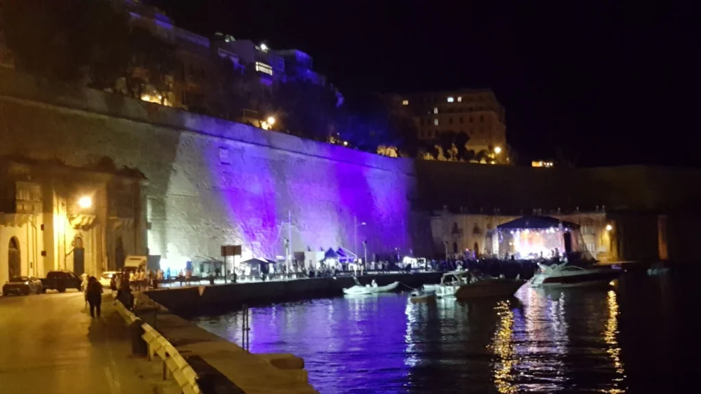 Malta Jazz Festival stage on the waterfront below Valletta's fortifications at night