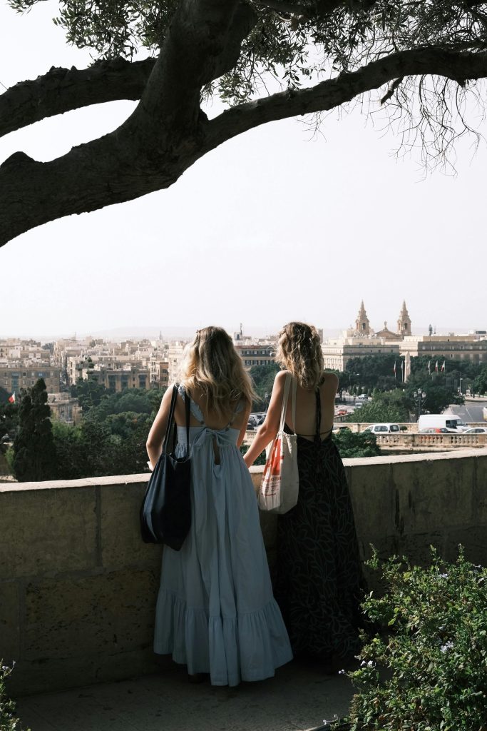 Two visitors looking out over Valletta from the Upper Barrakka Gardens, Malta