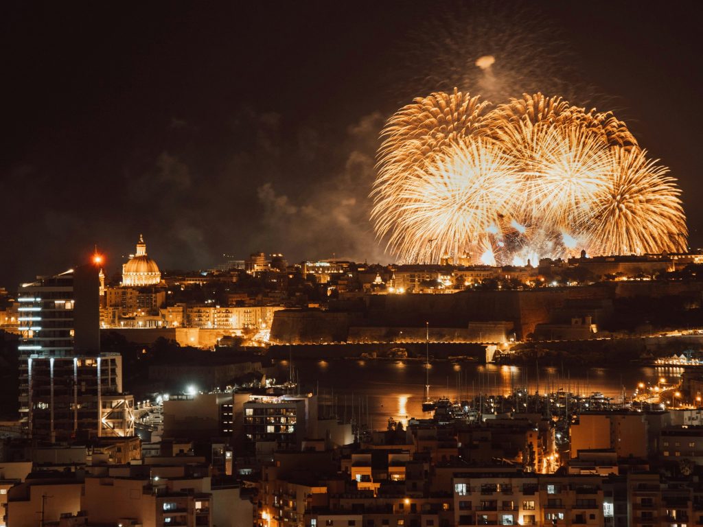 Malta Festivals. Fireworks bursting over the Valletta skyline and Grand Harbour at night, Malta