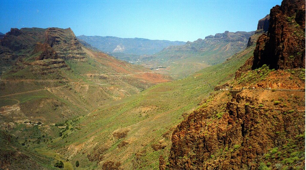 Mountain road in Gran Canaria with Roque Nublo volcanic rock formation visible in the background