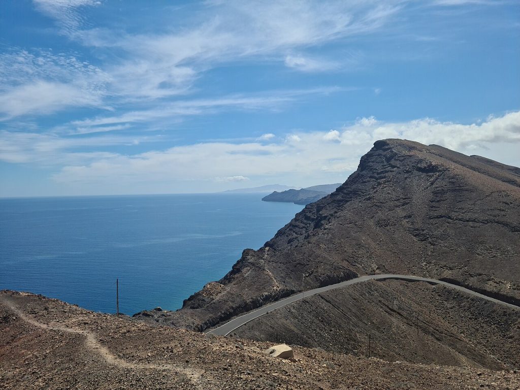 Drive 4 Faro de Entallada lighthouse Fuerteventura eastern coast -there's a cliff-top lighthouse above the Atlantic with Africa visible in the distance. 