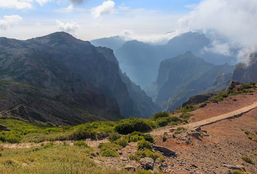 Drive 5 Pico do Arieiro summit road Madeira ER202 with mountain peaks above cloud layer and Atlantic ocean visible on horizon. 