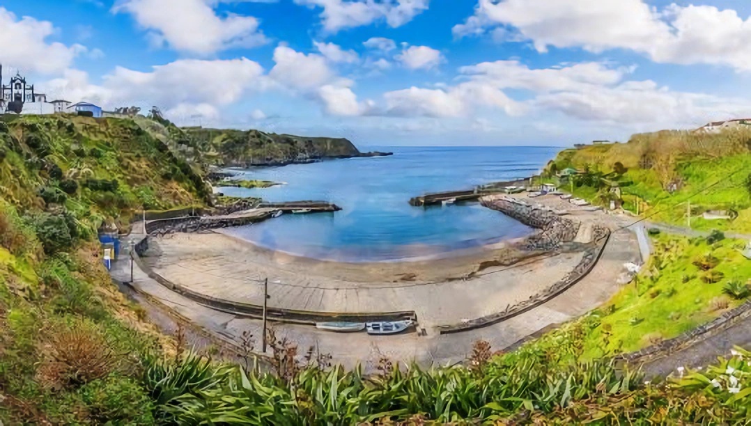 Porto Formoso fishing harbour and hilltop church, north coast of Sao Miguel