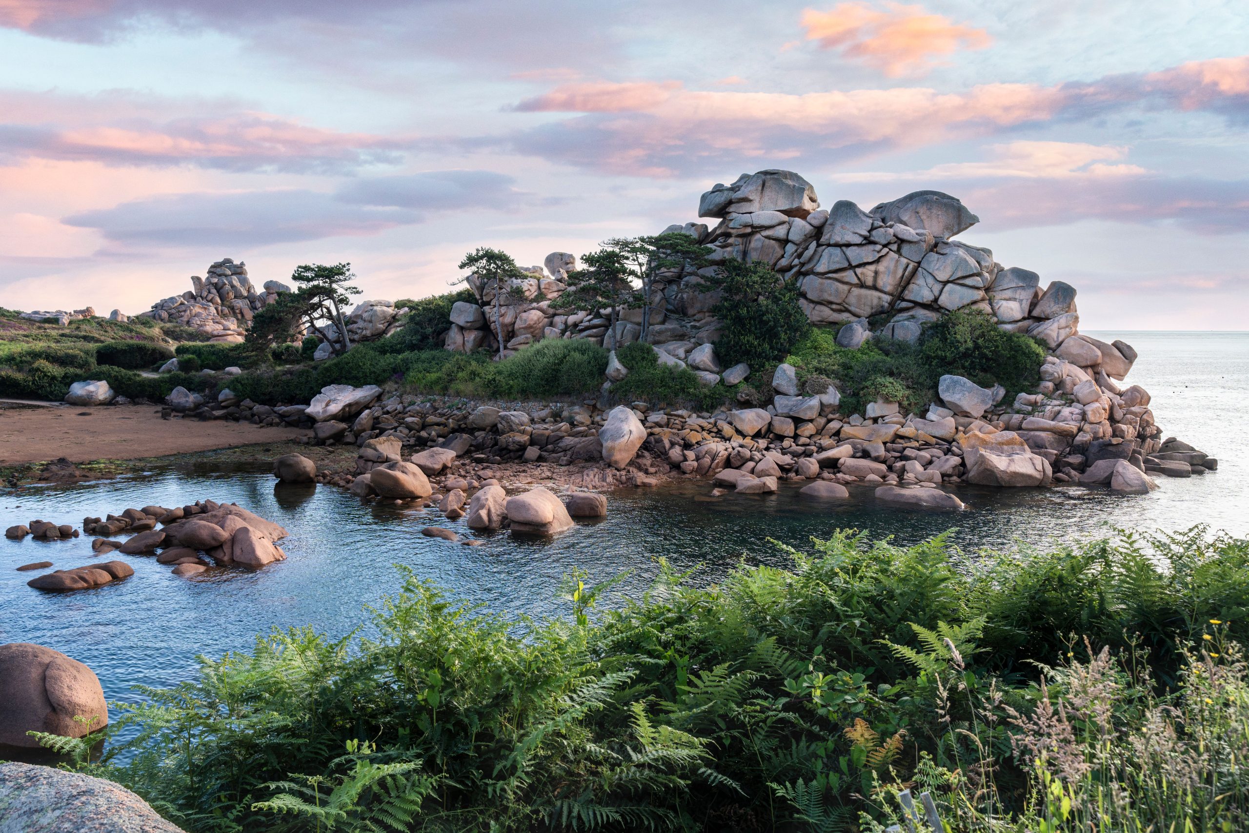 Giant rose-pink granite boulders on the coastal path, the Pink Granite Coast scenic drive, Brittany