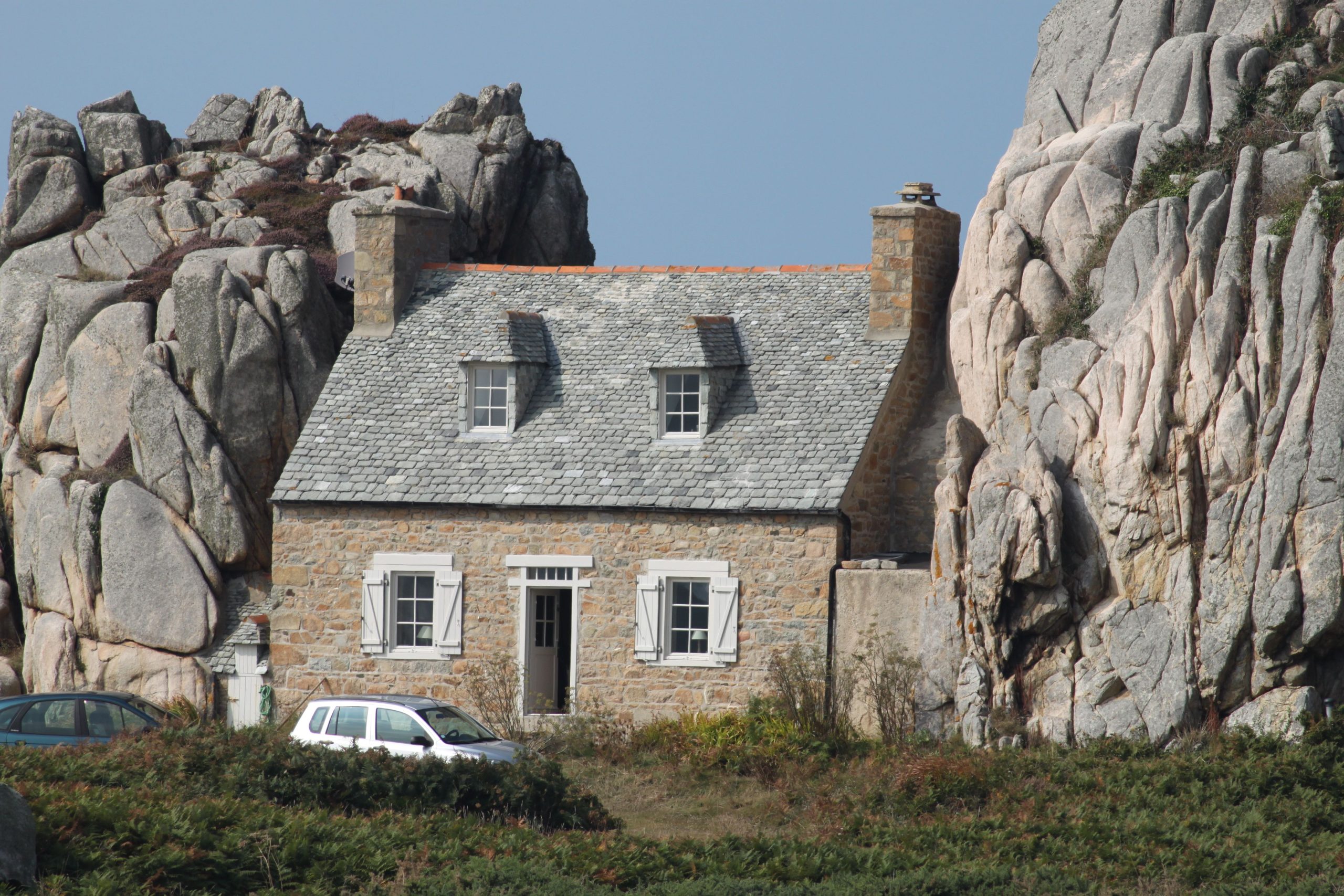 The famous house between two rocks at Plougrescant on the Côte des Ajoncs, Pink Granite Coast scenic drive