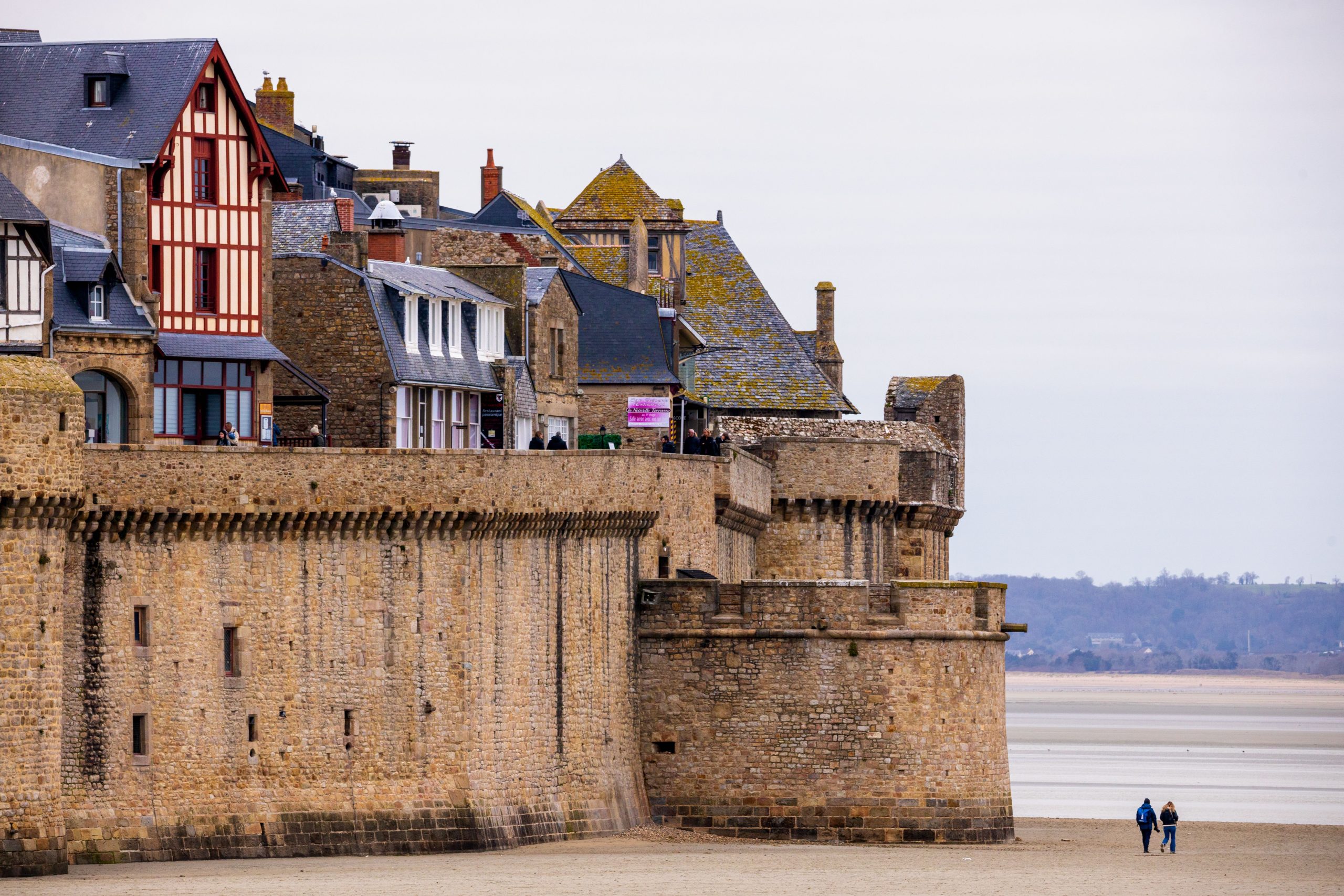Saint-Malo ramparts on the Emerald Coast scenic drive, with the tidal beach and offshore forts at low water