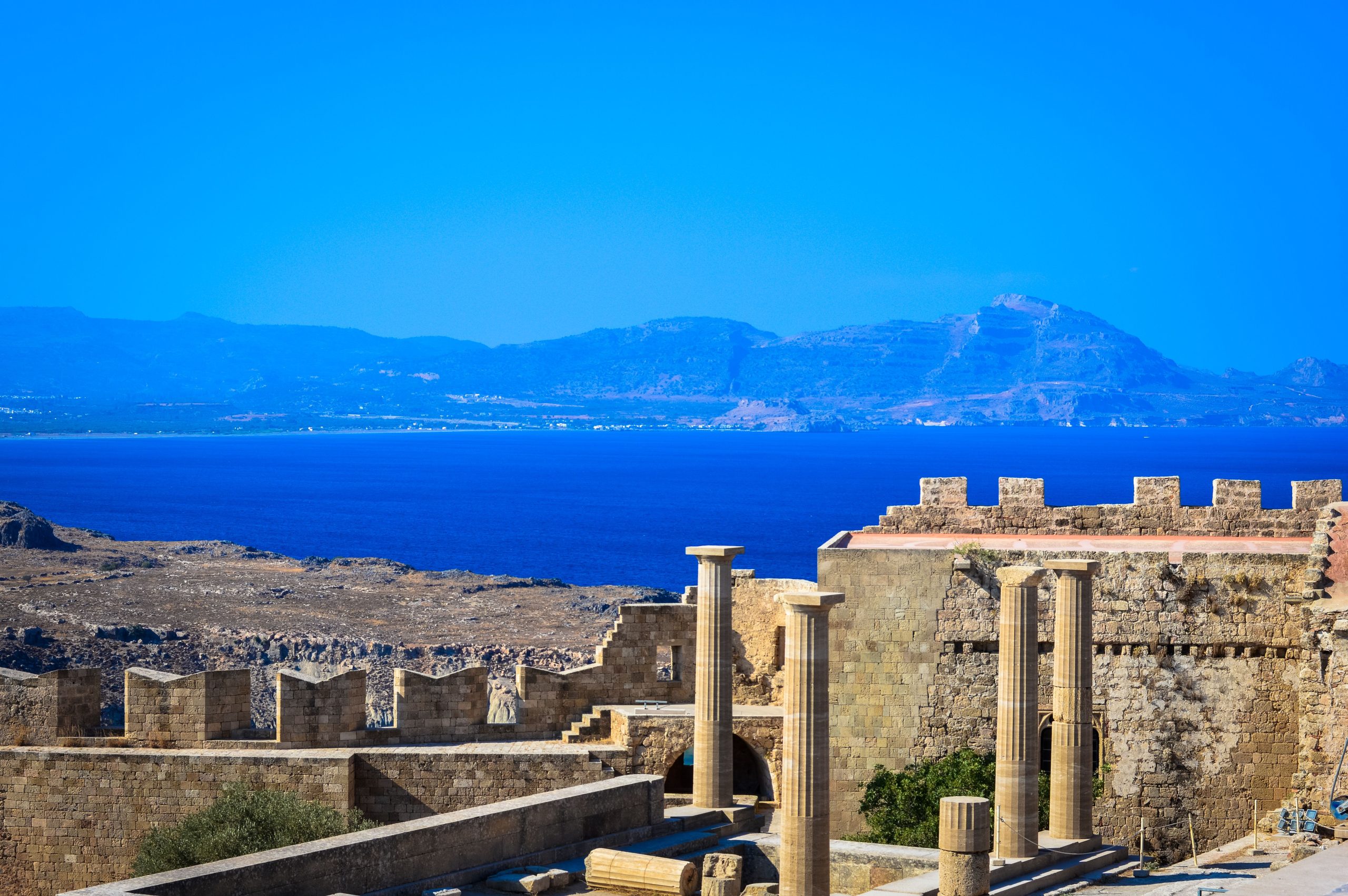 Car hire in Rhodes opens up the coast road to Lindos acropolis and the white village below